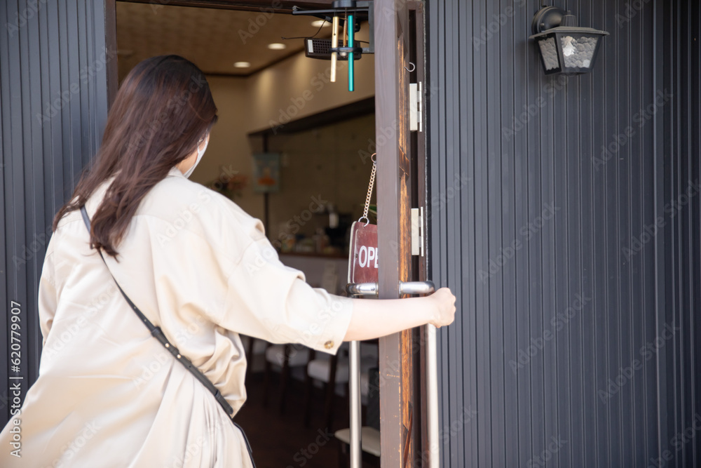 ドアを開けようとする女性 ドアを開けようとする女性