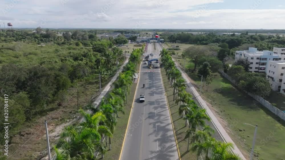 Aerial flyover palm tree road to entrance of SAN ISIDRO Air Base with checkpoint in Dominica Republic Aerial flyover palm tree road to entrance of SAN ISIDRO Air Base with checkpoint in Dominica Republic