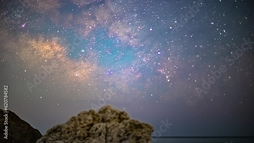 Time lapse at night of starry sky in Cyprus aphrodites rock viewpoint with shooting stars  photo