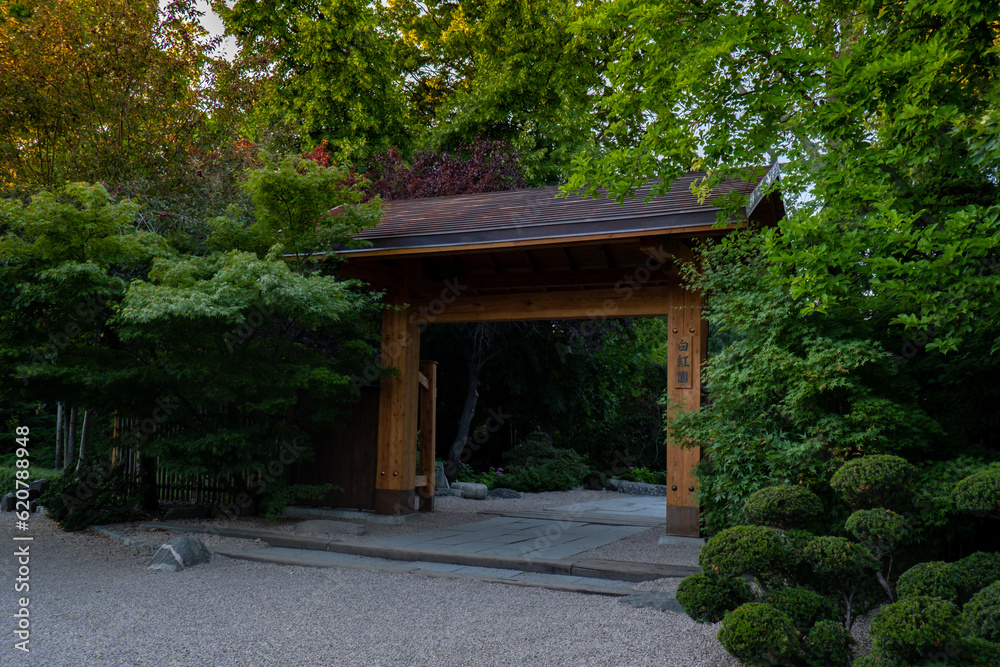Japanese garden door gate Pergola with green plants at Centennial Hall in Wroclaw. Poland in summer. Garden Archway in full bloom Greenery Biophilia design Flowers green areas healthy space Japanese garden door gate Pergola with green plants at Centennial Hall in Wroclaw. Poland in summer. Garden Archway in full bloom Greenery Biophilia design Flowers green areas healthy space