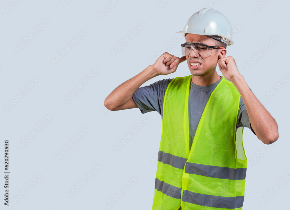 Young engineer with problems in ear isolated. Builder with ear pain. engineer earache problems Young engineer with problems in ear isolated. Builder with ear pain. engineer earache problems