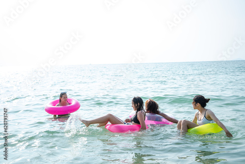 Group of beautiful young women having fun on a beach on a summer day,Enjoying vacation. © visoot