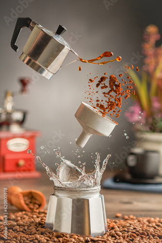 Italian coffee maker with a coffee splash. Flying Moka pot. Close up.