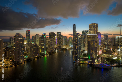 View from above of brightly illuminated high skyscraper buildings in downtown district of Miami Brickell in Florida, USA. American megapolis with business financial district at night © bilanol
