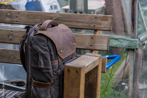 The backpack is standing on a wooden bench in close-up.