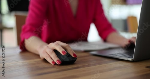 Business woman manually typing on computer keyboard using a mouse sitting at desk in office or working at home. Remote work teleworking or searching for information on network