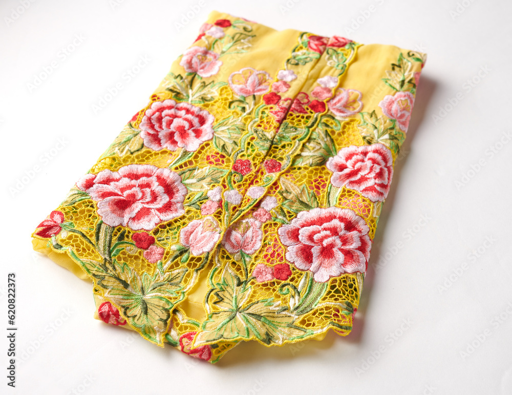 Close-up details shot of traditional yellow kebaya dress. Nyonya kebaya in selective focus. Close-up details shot of traditional yellow kebaya dress. Nyonya kebaya in selective focus.