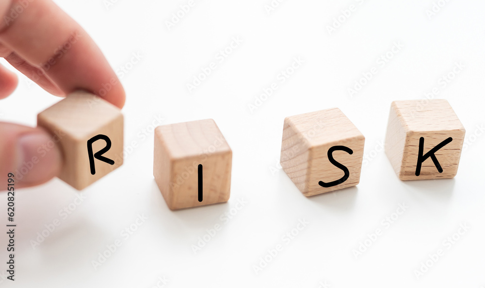 Risk in business investment. Word risk white in the wood block on paper analyse financial graph. Investment Concept. Risk in business investment. Word risk white in the wood block on paper analyse financial graph. Investment Concept.