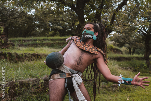 Mayan warrior hitting a rubber ball with his hip photo
