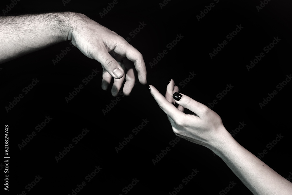 Fototapeta premium Touch of two hands. Man and woman hand about to touch with index finger. Couple in love reaching to each other. Hand try to touch. Couple hands reaching towards each other. Couple hand touch.