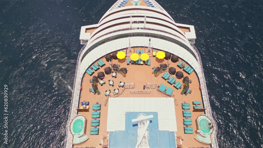 An aerial drone flies overhead of a cruise ship anchored in the bay of Cabo San Lucas, Mexico