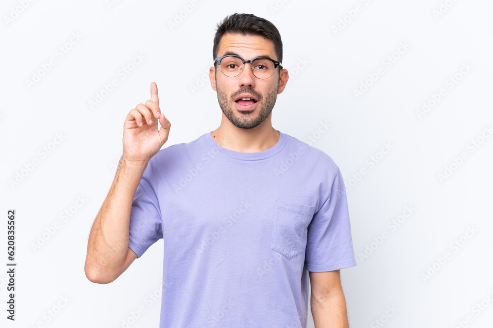 Young caucasian man isolated on white background thinking an idea pointing the finger up Young caucasian man isolated on white background thinking an idea pointing the finger up