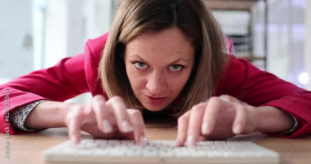 Aggressive woman is typing on computer keyboard in office. Annoyed manager typing on keyboard Aggressive woman is typing on computer keyboard in office. Annoyed manager typing on keyboard