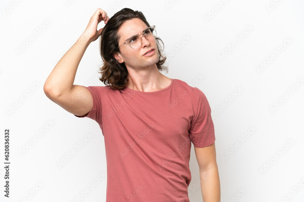Young handsome man isolated on white background having doubts while scratching head Young handsome man isolated on white background having doubts while scratching head
