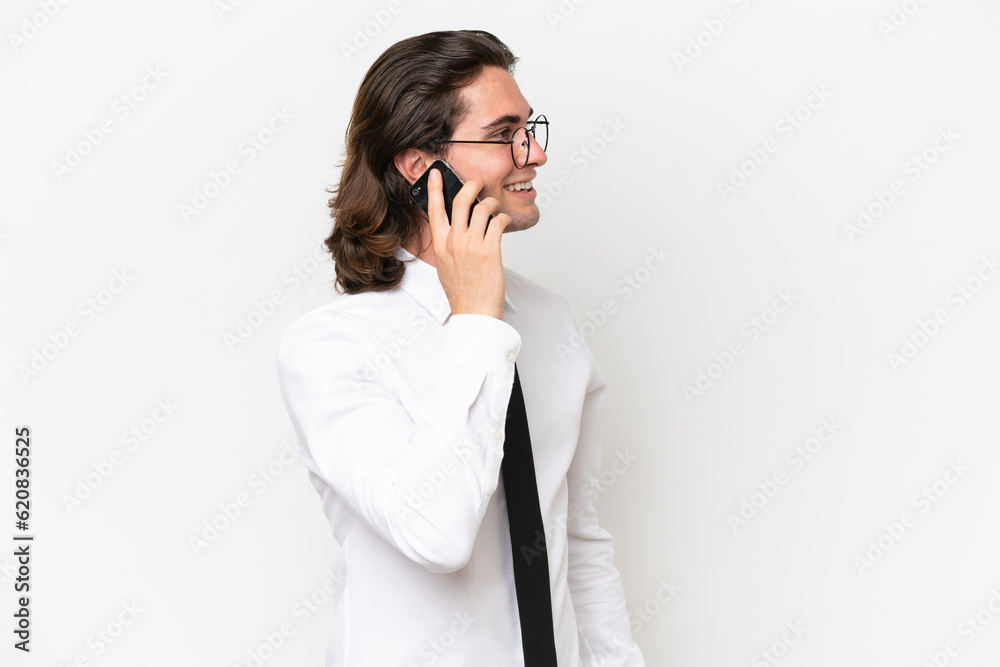 Business handsome man isolated on white background keeping a conversation with the mobile phone with someone Business handsome man isolated on white background keeping a conversation with the mobile phone with someone