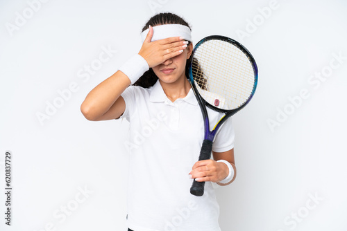 Young tennis player woman isolated on white background covering eyes by hands. Do not want to see something © luismolinero