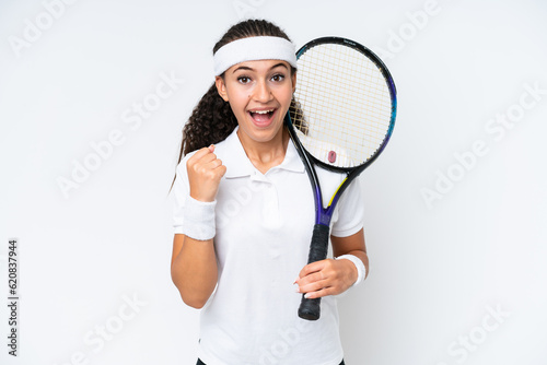 Young tennis player woman isolated on white background celebrating a victory in winner position © luismolinero