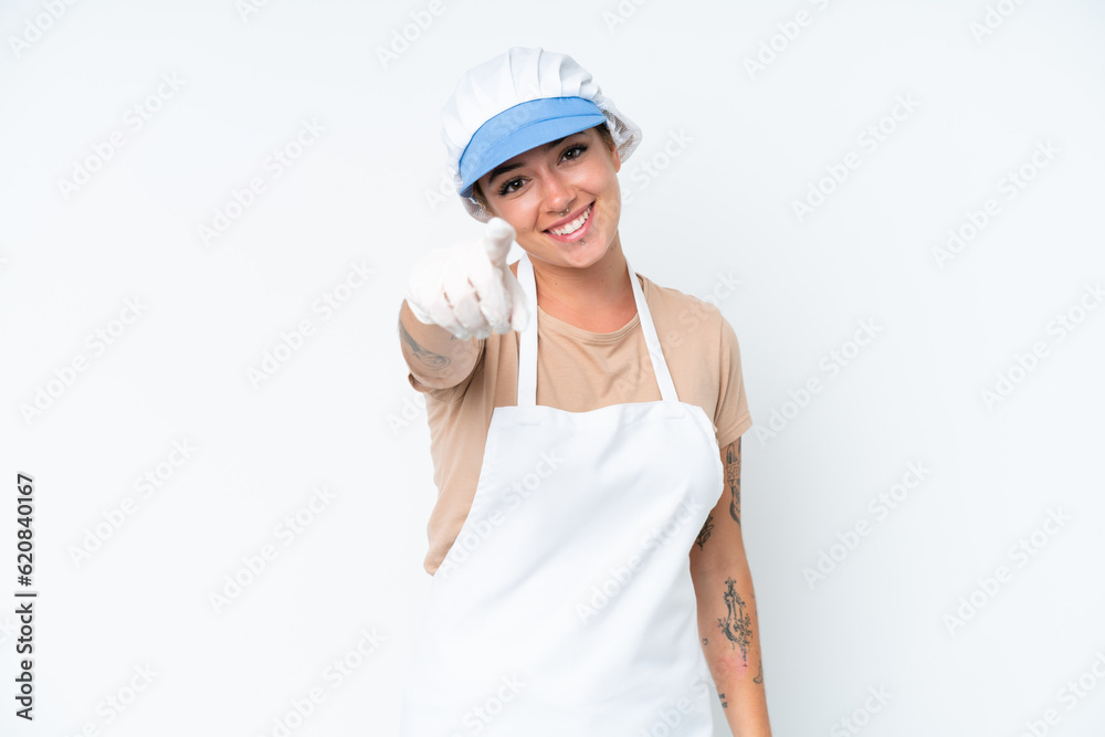 Fishmonger wearing an apron and holding a raw fish isolated on white background pointing front with happy expression Fishmonger wearing an apron and holding a raw fish isolated on white background pointing front with happy expression
