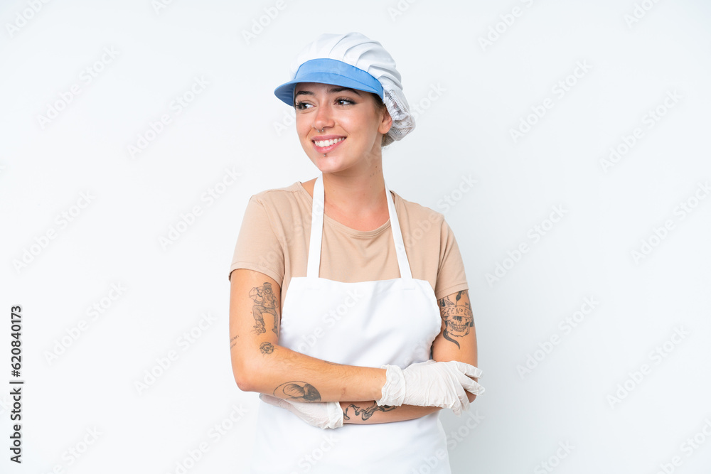 Fishmonger wearing an apron and holding a raw fish isolated on white background looking to the side and smiling Fishmonger wearing an apron and holding a raw fish isolated on white background looking to the side and smiling