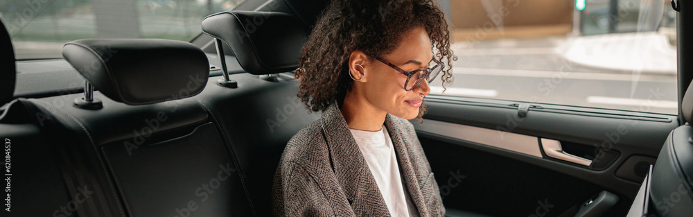 Executive woman manager working on laptop sitting car leather backseat on the way to office Executive woman manager working on laptop sitting car leather backseat on the way to office