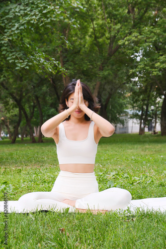 Yoga asian woman practicing yoga lesson, breathing, meditation, doing Ardha Padmasana exercises. lotus poses with mudragesture.