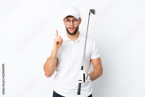 Handsome young man playing golf isolated on white background intending to realizes the solution while lifting a finger up