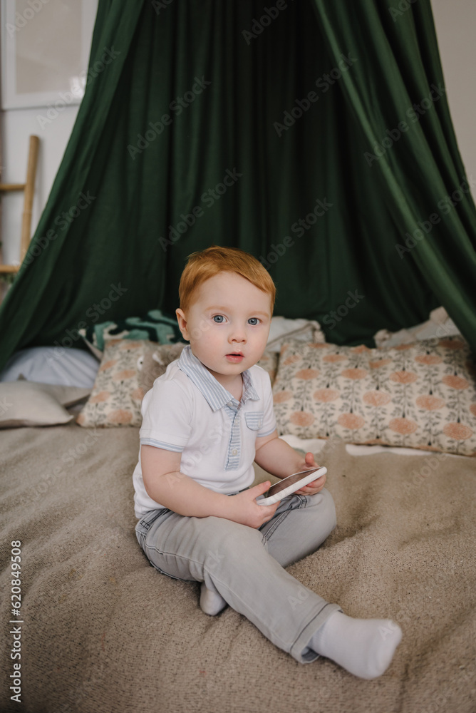 Toddler playing mobile device video game. Child watching cartoons online on phone at home alone. Cute little boy using smartphone, looking at screen. Kid gen Z using parental control app on cell phone Toddler playing mobile device video game. Child watching cartoons online on phone at home alone. Cute little boy using smartphone, looking at screen. Kid gen Z using parental control app on cell phone