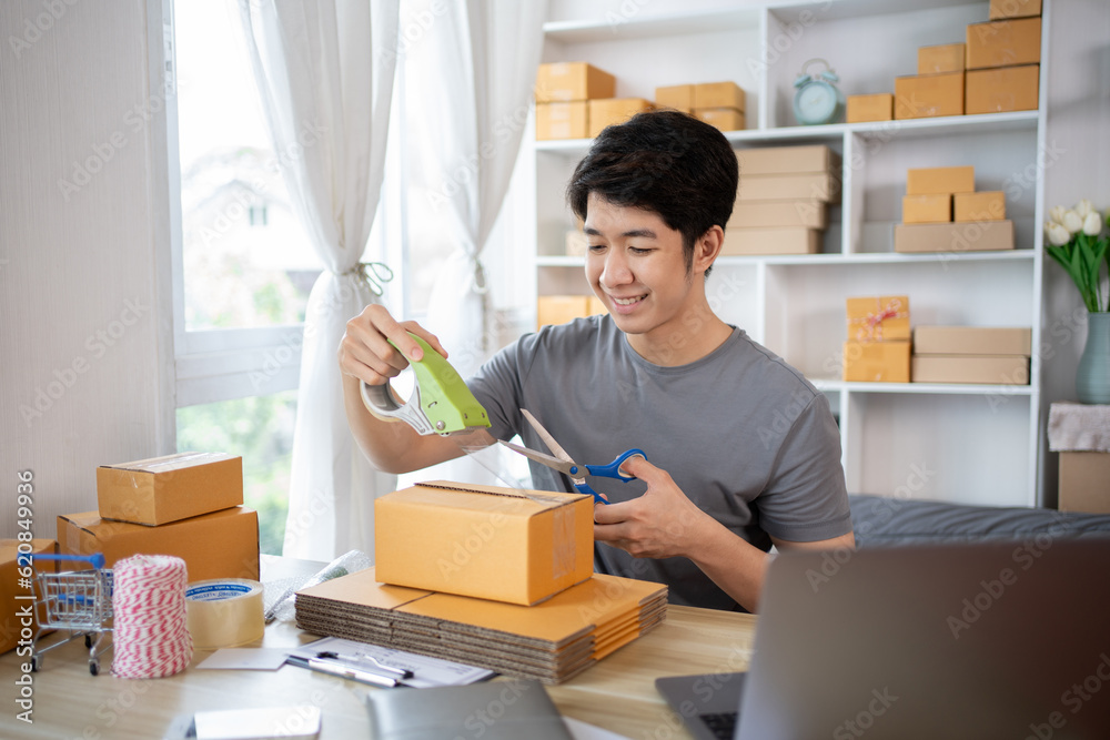 Efficient Home-Based Delivery, Man Packing Items into Post Box for Customer Shipping, Online Shopping and Small Business Entrepreneurship, Packing box, Sell online, Freelance working. Efficient Home-Based Delivery, Man Packing Items into Post Box for Customer Shipping, Online Shopping and Small Business Entrepreneurship, Packing box, Sell online, Freelance working.
