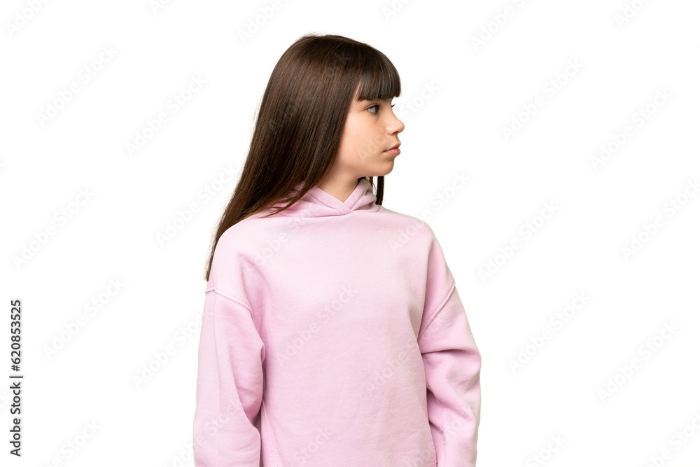 Little girl over isolated green chroma key background looking to the side Little girl over isolated green chroma key background looking to the side