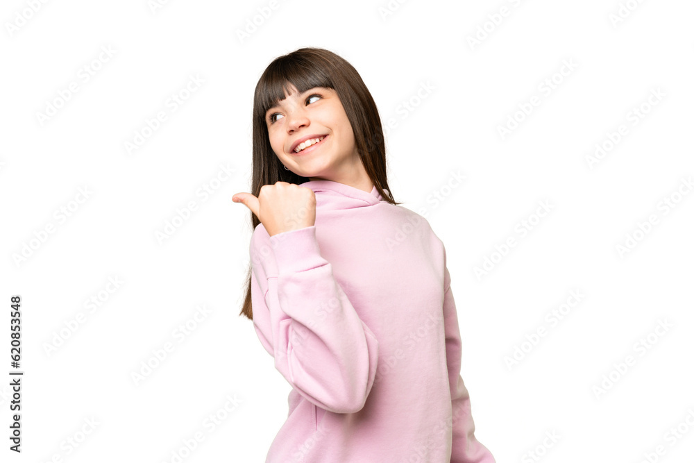 Little girl over isolated green chroma key background pointing to the side to present a product Little girl over isolated green chroma key background pointing to the side to present a product
