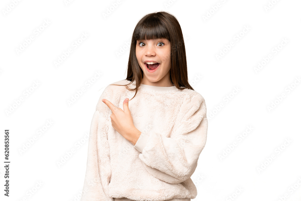 Little girl over isolated green chroma key background surprised and pointing side Little girl over isolated green chroma key background surprised and pointing side