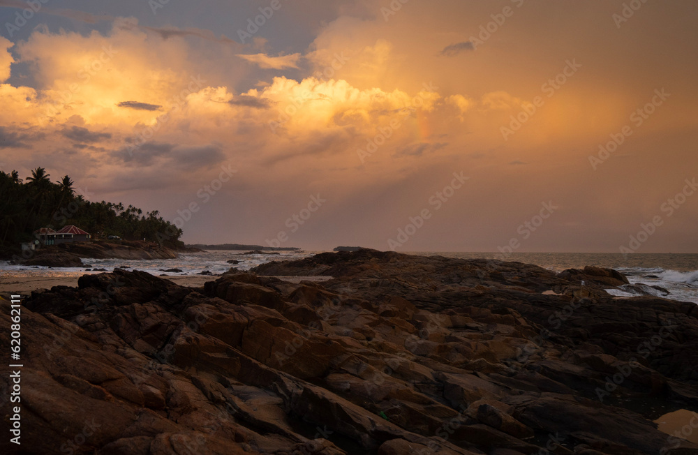 Obraz premium sunset over the sea, beautiful seascape during sunset featuring a vivid orange and yellow sky with golden sunlight , peaceful coastal scenery perfect for travel, nature, and relaxation themes.