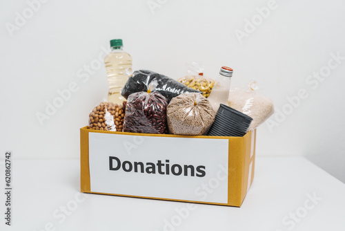 Donation box different dry food donations on the table. charity, support and concept