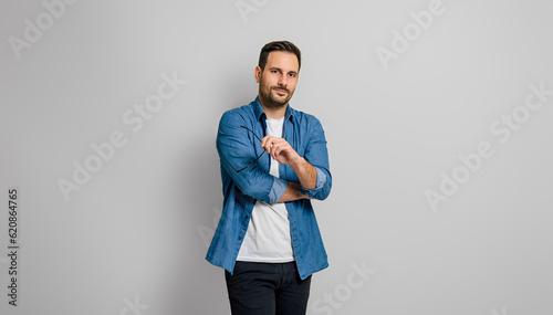 Schilderij op canvas Portrait of confident charming businessman holding glasses and posing seriously