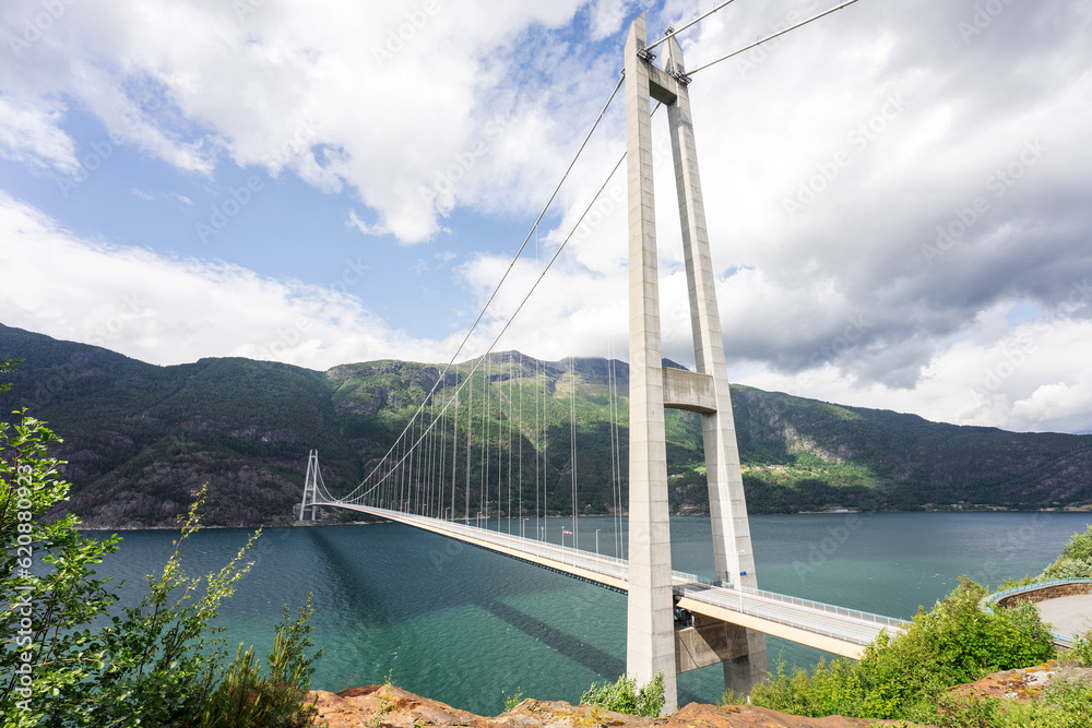 Obraz premium Hardanger Bridge is the longest suspension bridge in Norway. Hardangerbrua connecting two sides of Hardangerfjorden. Hardangerbrua bridge close to Ulvik in Western Norway