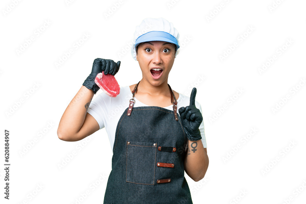 Butcher woman wearing an apron and serving fresh cut meat over isolated chroma key background intending to realizes the solution while lifting a finger up Butcher woman wearing an apron and serving fresh cut meat over isolated chroma key background intending to realizes the solution while lifting a finger up