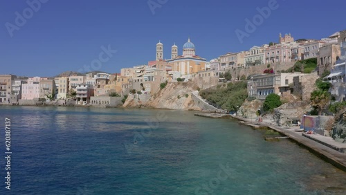 Aerial: Slow panoramic drone shot of Asteria beach in Ermoupoli of Syros island in Greece on a sunny day photo