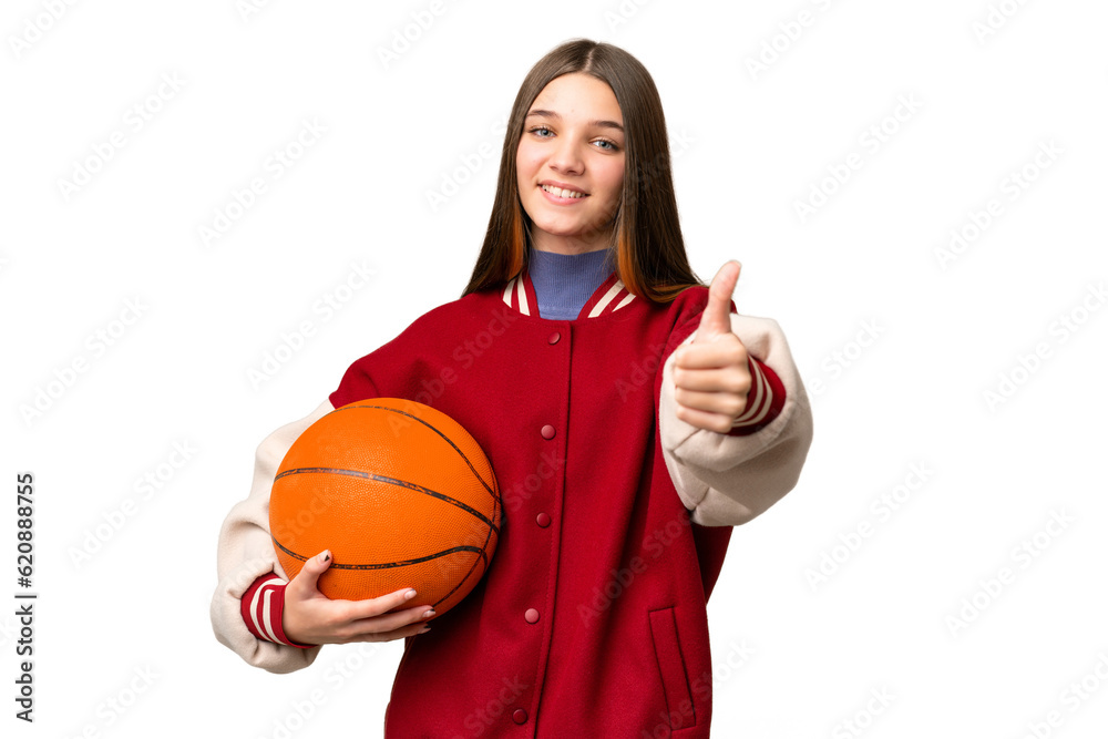Teenager girl playing basketball over isolated chroma key background with thumbs up because something good has happened Teenager girl playing basketball over isolated chroma key background with thumbs up because something good has happened