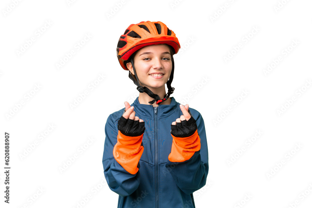 Teenager cyclist girl over isolated chroma key background making money gesture Teenager cyclist girl over isolated chroma key background making money gesture