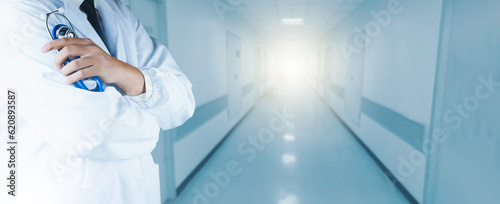 Healthcare and Medical concept of male doctor in white coat with stethoscope, Medicine doctor with stethoscope in hand and Patients come to the hospital background. Insurance.