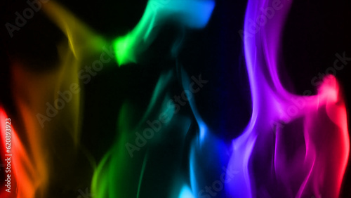 Turn fire into rainbow colors. Colorful Fire Flame against a background of black, abstract. a mysterious, vibrant smoke. blurry, colored lines in an abstract design.