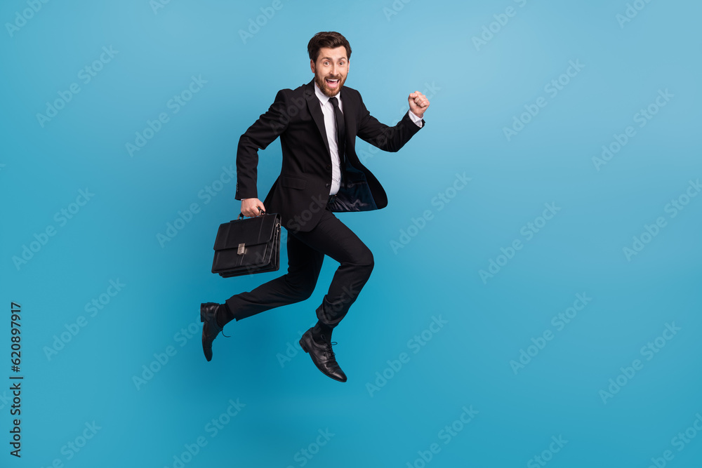 Full body photo of crazy run guy with diplomat suitcase businessman office manager hurry go his interview isolated on blue color background Full body photo of crazy run guy with diplomat suitcase businessman office manager hurry go his interview isolated on blue color background