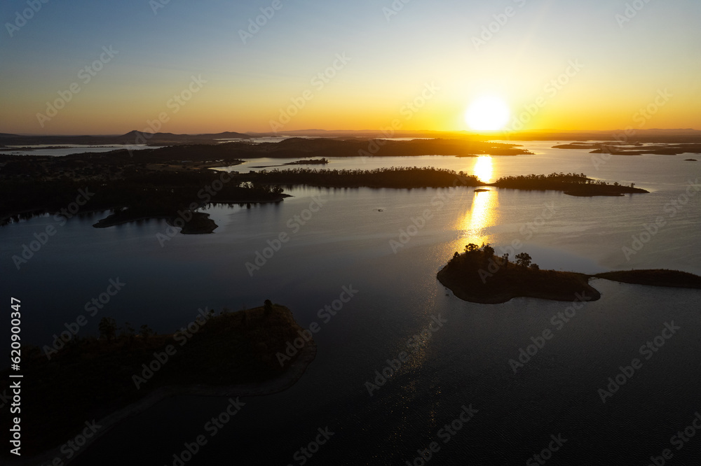 Alqueva, Alentejo lake - Aerial view of the largest artificial lake in Spain or the boarder with Portugal at sunrise - Low water levels due to heat wave and climate change Alqueva, Alentejo lake - Aerial view of the largest artificial lake in Spain or the boarder with Portugal at sunrise - Low water levels due to heat wave and climate change