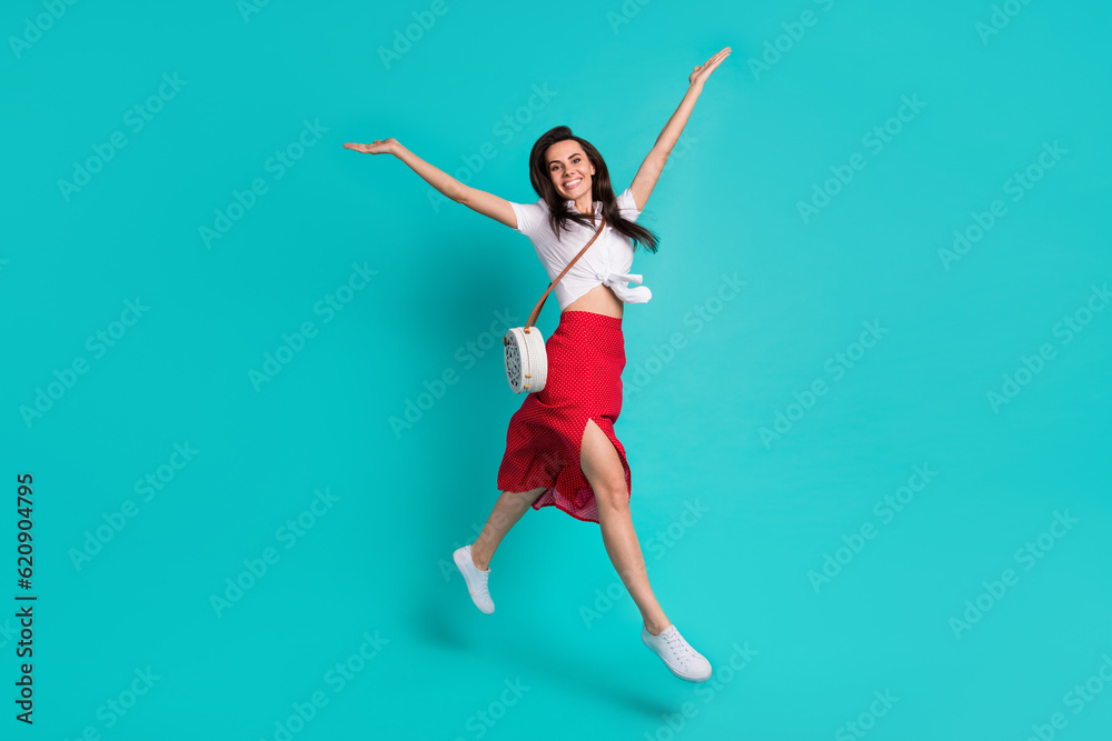 Photo of charming shiny lady dressed white crop top jumping high having fun isolated turquoise color background