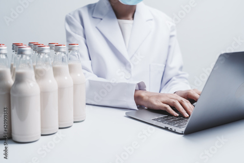Quality control laboratory dairy factory professional people checking milk bottles quality  Dairy factory industry products.