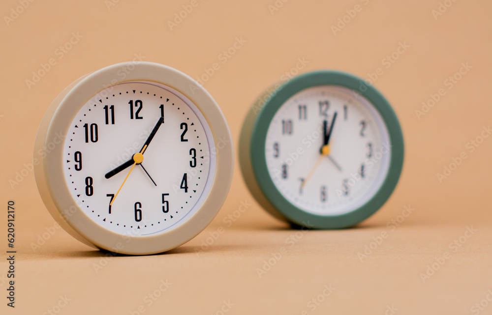 Alarm clock. Beautiful modern clock lies on paper background. time clock time standstill time off work working with time time concept Alarm clock. Beautiful modern clock lies on paper background. time clock time standstill time off work working with time time concept