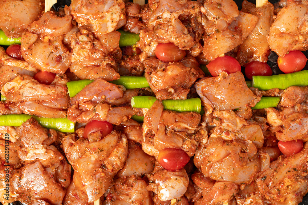 Chicken skewer. Close-up chicken skewers with raw sauce. Food background