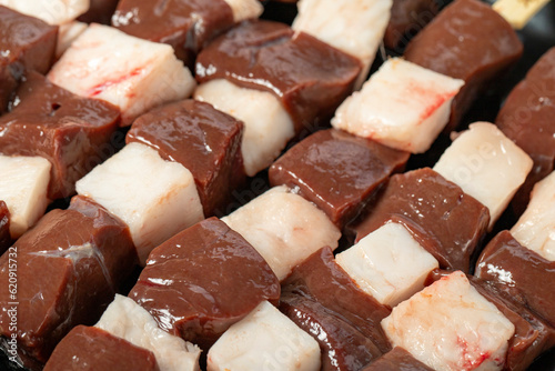Liver skewer. Close-up raw liver shish kebab. Food background.Turkish cuisine delicacies. Local name ciger sis