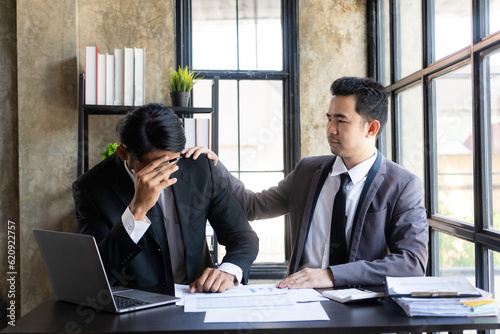 Принти на полотні Sad asian businessman grieving life problems with support of his best friend and