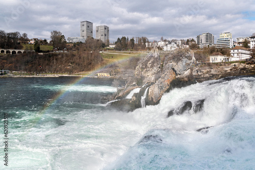 Rainbow over Rhine Falls with townscape in background, Neuhausen, Switzerland photo